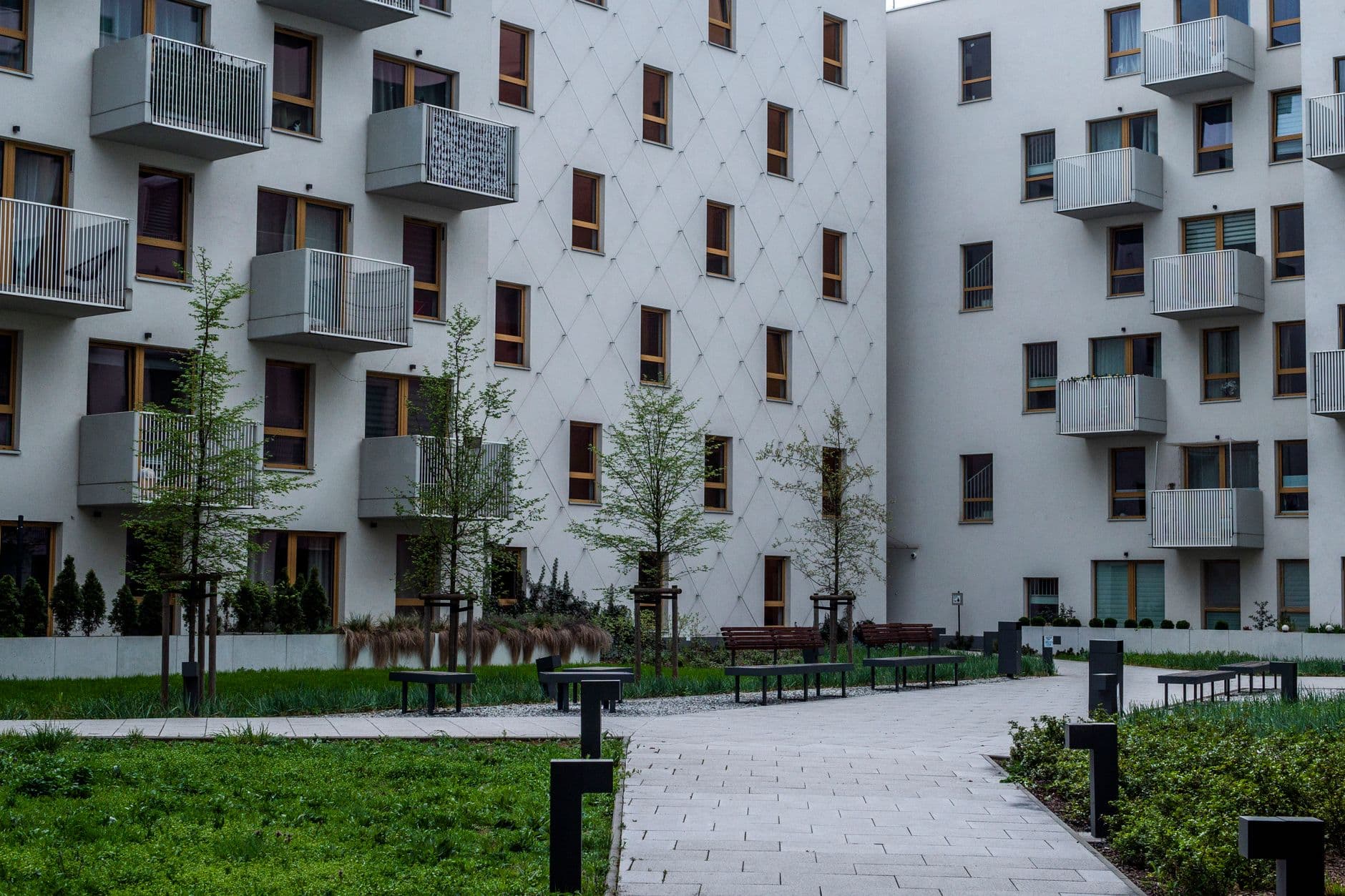 Contemporary apartment complex with landscaped courtyard and balconies